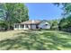 Wide angle shot of a spacious backyard with well-maintained lawn, fence, and mature trees surrounding the property at 4735 Rabbit Farm Rd, Loganville, GA 30052