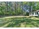 Expansive backyard space with lawn, mature trees, and a fence at 4735 Rabbit Farm Rd, Loganville, GA 30052
