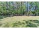 Fenced backyard with lush green grass, mature trees, and natural setting offering privacy and space at 4735 Rabbit Farm Rd, Loganville, GA 30052