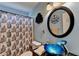 The updated bathroom offers a vessel sink, dark countertops, and a shower with a unique shower curtain at 4735 Rabbit Farm Rd, Loganville, GA 30052