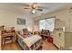 This bedroom features hardwood floors, a fan, and a bright window for plenty of natural light at 4735 Rabbit Farm Rd, Loganville, GA 30052