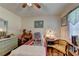 A charming bedroom offers hardwood floors, a ceiling fan, and natural light from the window at 4735 Rabbit Farm Rd, Loganville, GA 30052