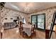 Dining room boasts floral wallpaper, hardwood floors, and an archway to the living room at 4735 Rabbit Farm Rd, Loganville, GA 30052