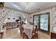 Dining room showcases floral wallpaper, hardwood floors, and an archway to the living room at 4735 Rabbit Farm Rd, Loganville, GA 30052