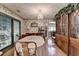Dining room with floral wallpaper, hardwood floors, chandelier, and a built-in china cabinet at 4735 Rabbit Farm Rd, Loganville, GA 30052