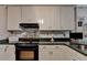 This kitchen is equipped with solid surface counters and stainless appliances at 4735 Rabbit Farm Rd, Loganville, GA 30052