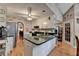 This cozy kitchen has an island, granite countertops, stainless appliances, and hardwood floors at 4735 Rabbit Farm Rd, Loganville, GA 30052