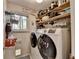 This laundry room features a washer, dryer, and shelving at 4735 Rabbit Farm Rd, Loganville, GA 30052