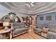 Living room boasts hardwood floors and a tray ceiling with overhead lighting and blue accent wall at 4735 Rabbit Farm Rd, Loganville, GA 30052