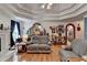 Spacious living room featuring hardwood floors, tray ceiling, and access to other rooms at 4735 Rabbit Farm Rd, Loganville, GA 30052