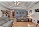 Comfortable living room with a decorative ceiling, hardwood floors, and a cozy fireplace at 4735 Rabbit Farm Rd, Loganville, GA 30052