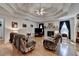 Comfortable living room with a decorative ceiling, hardwood floors, and a cozy fireplace at 4735 Rabbit Farm Rd, Loganville, GA 30052
