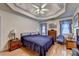 This main bedroom features tray ceilings, hardwood floors, and two windows for natural light at 4735 Rabbit Farm Rd, Loganville, GA 30052