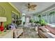 Bright sunroom featuring stone floors, multiple windows, and cozy seating arrangements at 4735 Rabbit Farm Rd, Loganville, GA 30052