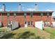 Brick townhouse backyard with a white fence and small patio at 215 Morris Ln, Woodstock, GA 30188