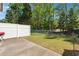 Fenced backyard with a concrete patio and green space at 215 Morris Ln, Woodstock, GA 30188