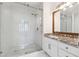 Modern bathroom with granite counters, glass shower, and tile floors at 215 Morris Ln, Woodstock, GA 30188