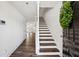 Inviting entryway with hardwood floors, a staircase, and a view into the open-concept living space at 215 Morris Ln, Woodstock, GA 30188