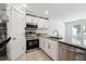 Modern kitchen featuring granite countertops, stainless steel appliances, and white cabinetry at 215 Morris Ln, Woodstock, GA 30188