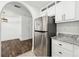 Kitchen space with stainless steel fridge, granite countertops, and access to living area at 215 Morris Ln, Woodstock, GA 30188