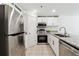 Bright kitchen with granite countertops, white cabinets, stainless steel appliances, and tile floors at 215 Morris Ln, Woodstock, GA 30188