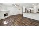 Open-concept living space featuring hardwood floors, a kitchen bar, and a fireplace at 215 Morris Ln, Woodstock, GA 30188