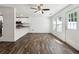 Open-concept living space with hardwood floors, stainless steel appliances, and a breakfast bar at 215 Morris Ln, Woodstock, GA 30188