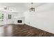 Spacious living room featuring modern hardwood floors, a fireplace, and natural light from windows at 215 Morris Ln, Woodstock, GA 30188