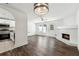 Bright open concept living area with fireplace, hardwood floors, and modern lighting fixtures at 215 Morris Ln, Woodstock, GA 30188