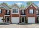 Charming brick townhouse with attached garage and well-maintained front yard at 215 Morris Ln, Woodstock, GA 30188