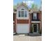 Beautiful brick townhouse with an attached garage and detailed trim at 215 Morris Ln, Woodstock, GA 30188
