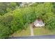 Aerial view of a home nestled in lush greenery with mature trees in a tranquil setting at 4618 Barkley Nw Dr, Acworth, GA 30101