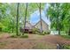 Exterior view of home with a spacious backyard, deck, and mature trees, perfect for outdoor living and entertaining at 4618 Barkley Nw Dr, Acworth, GA 30101