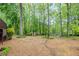 The expansive backyard boasts lush landscaping, mature trees, and a shed, creating a private and serene outdoor space at 4618 Barkley Nw Dr, Acworth, GA 30101