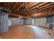 Unfinished basement with exposed ceiling and garage door, offers potential for customization and storage at 4618 Barkley Nw Dr, Acworth, GA 30101