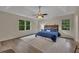 Large bedroom with tray ceiling, a ceiling fan, and lots of natural light from the two windows at 4618 Barkley Nw Dr, Acworth, GA 30101