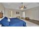 Bedroom featuring a tray ceiling, ceiling fan, wood floors, and access to an en-suite bathroom at 4618 Barkley Nw Dr, Acworth, GA 30101