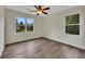 Bright bedroom with wood flooring, ceiling fan, and views of backyard at 4618 Barkley Nw Dr, Acworth, GA 30101
