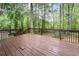 A spacious wooden deck overlooks a lush backyard with mature trees, offering a private outdoor retreat at 4618 Barkley Nw Dr, Acworth, GA 30101