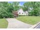 Landscaped front yard with a long driveway leading to a charming single-Gathering home at 4618 Barkley Nw Dr, Acworth, GA 30101
