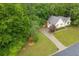 Charming home nestled among mature trees with a long driveway and well-maintained lawn at 4618 Barkley Nw Dr, Acworth, GA 30101