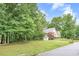 Home with well-maintained lawn, large trees, and a convenient driveway at 4618 Barkley Nw Dr, Acworth, GA 30101