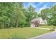 Beautiful home with a lush front yard, mature trees, and a long driveway at 4618 Barkley Nw Dr, Acworth, GA 30101