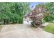 Spacious driveway and garage of this well-maintained home surrounded by lush greenery at 4618 Barkley Nw Dr, Acworth, GA 30101