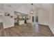 Bright living room showcasing wood floors, high ceilings, modern lighting, and seamless access to the kitchen at 4618 Barkley Nw Dr, Acworth, GA 30101