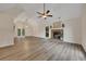 Large living room featuring a brick fireplace, new flooring, and a ceiling fan at 4618 Barkley Nw Dr, Acworth, GA 30101