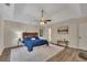 Spacious main bedroom featuring a tray ceiling, ceiling fan, wood floors, and a serene ambiance at 4618 Barkley Nw Dr, Acworth, GA 30101