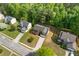 Expansive aerial shot of a neighborhood showcasing a charming home surrounded by lush green trees and well-kept lawns at 1450 Steam Engine Way, Conyers, GA 30013