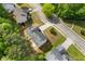 An aerial view of a home in a neighborhood with mature trees and landscaping showing the roof, driveway, and surrounding streets at 1450 Steam Engine Way, Conyers, GA 30013