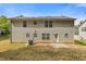 Exterior of the home features a modest backyard with a small concrete patio, ideal for outdoor living at 1450 Steam Engine Way, Conyers, GA 30013